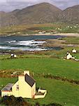View to village with scattered cottages, beach and Slieve Miskish mountains from Ring of Beara tourist route on Beara Peninsula, Ballydonegan, County Cork, Munster, Republic of Ireland, Europe