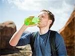 man drinking water in the desert