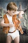 little boy pretending to be cowboy