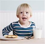 little boy eating breakfast