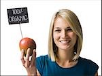 woman holding an organic mango