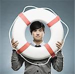 man looking through the hole of a life preserver