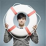 man looking through the hole of a life preserver