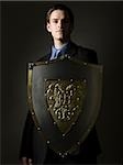 businessman holding a shield