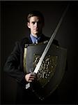 businessman holding a sword and shield