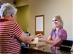 receptionist talking to patients at a doctor's office