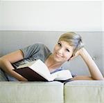 woman reading a book on the couch