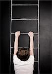 man hanging from a ladder