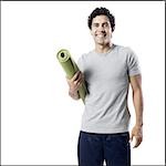 man holding a yoga mat