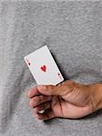 man holding an ace card behind his back