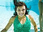 teenage girl in a bathing suit swimming in a pool