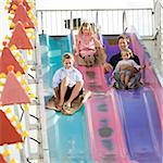 family at the carnival riding on the fun slide together