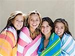 four teenage girls wrapped in towels
