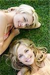 two women lying on the grass