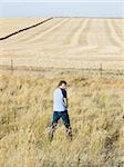 man urinating along the side of road