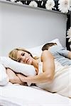 couple with marriage problems lying in bed