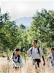 father hiking with his two kids