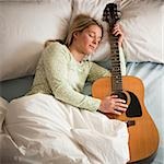 woman sleeping with her guitar