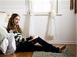 woman sitting in her room writing in a journal