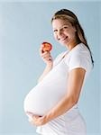 pregnant woman eating an apple