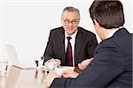 Two businessmen talking in conference room, Munich, Bavaria, Germany