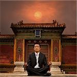 businessman sitting in front of a chinese style building