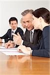 Four businesspeople talking in conference room, Bavaria, Germany