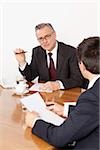 Two businessmen talking in conference room, Munich, Bavaria, Germany