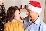 Girl and grandfather with Santa hat