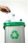 Man putting plastic bottle in recycling bin, Germany