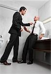 Two businessmen arguing in the restroom