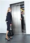 Businessman and businesswoman at elevator