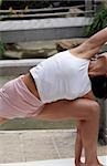 Darkhaired Woman doing a Physical Exercise - Stretching - Yoga - Physicalness