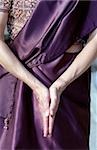 Woman bringing the Palms of her Hands together over her Lap - Prayer - Tradition