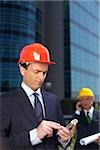 Businessman with hardhat using a mobile phone
