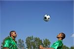 Two Brazilian soccer players heading the ball