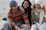 Three Friends in warm Clothing at the Beach - Friendship - Trip - Beach - Season