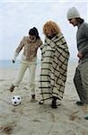 Three Friends playing Football at the Beach - Fun - Game - Season - Coldness