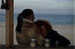 Redhaired Woman leaning against a Friend - Coldness - Friendship - Beach - Season