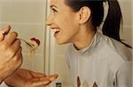 Man feeding his Girlfriend with a forkfull of Spaghetti - Love - Cooking - Dinner