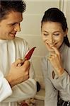 Young Man showing his Girlfriend a red Pepper - Fun - Togetherness - Communication - Spice
