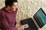 Man typing something into his Laptop - Communication - Living Room - Home