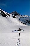 Man Snowshoeing Crow Pass Chugach Mtns Southcentral AK Tracks Cabin Snow Winter