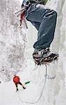 Two ice climbers climbing frozen waterfall in Hunter Creek Canyon, Chugach Mountains, Alaska