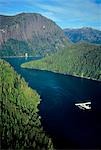 Aerial view of float plane flying over Misty Fjords' *Punchbowl* in Southeast Alaska during Summer