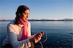 Woman listens to iPod at Bishops Beach at Kachemak Bay in Homer, Alaska