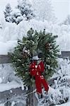 Holiday christmas wreath hanging on snow covered split rail fence Anchorage Alaska Southcentral Winter