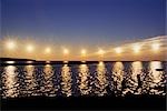 Multiple exposure of arctic midnight sun moving across horizon over Arctic Coast ANWR w/silhouette antlers