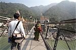 People Crossing Lakshman Jhula Bridge over Ganges River, Rishikesh, Uttarakhand, India