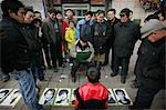 A crowd watching a man draw a portrait of a boy on the street,Xian,Xi'an,Capital of Shaanxi Province,China